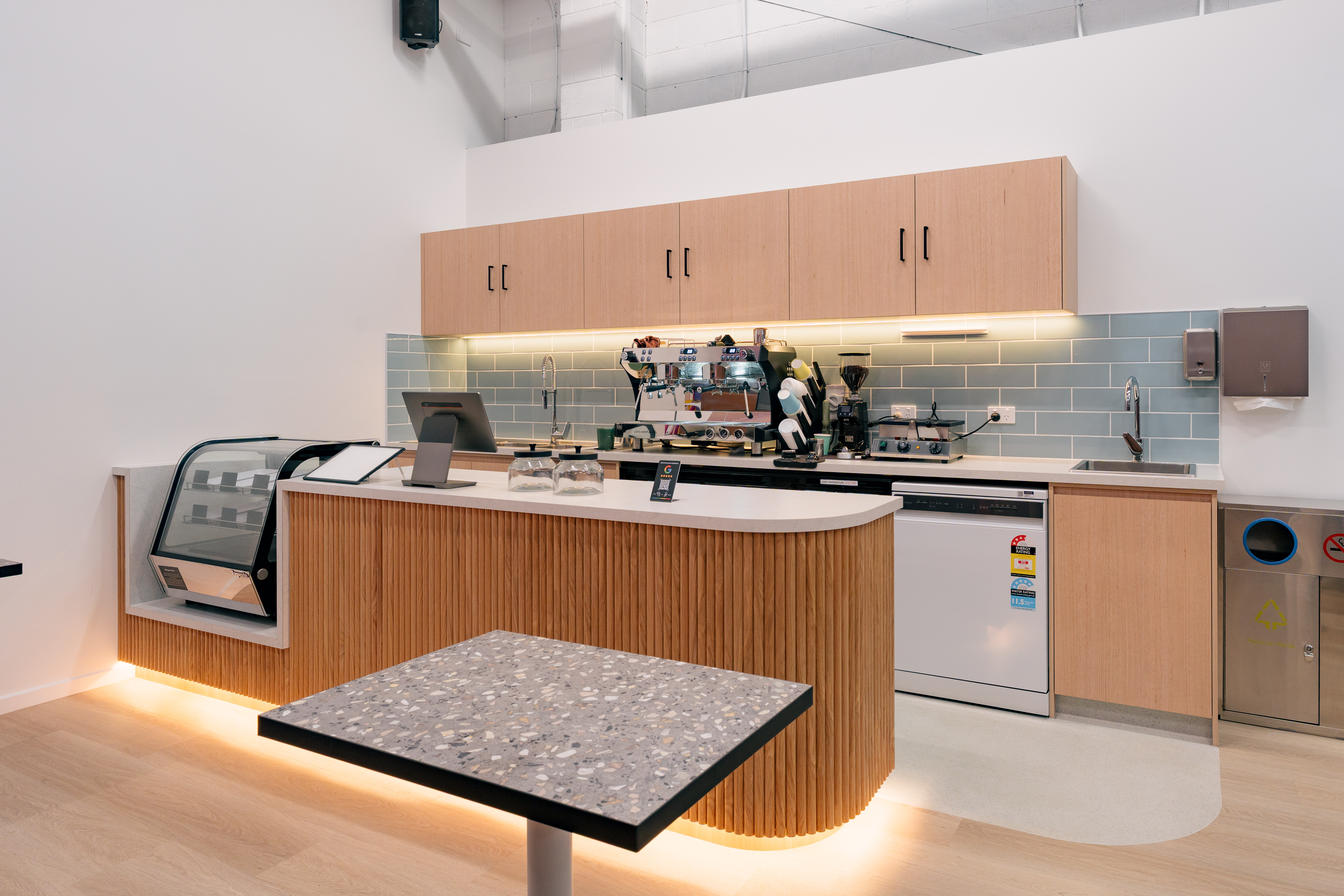 A cafe seating corner where adults can relax while staying connected to the nearby play space.